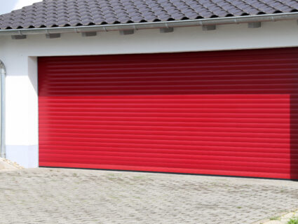 red roller garage door in a detached garage