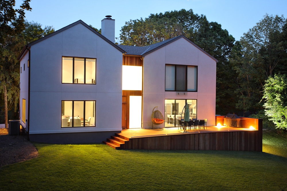 double gabled house at night with large aluminium windows