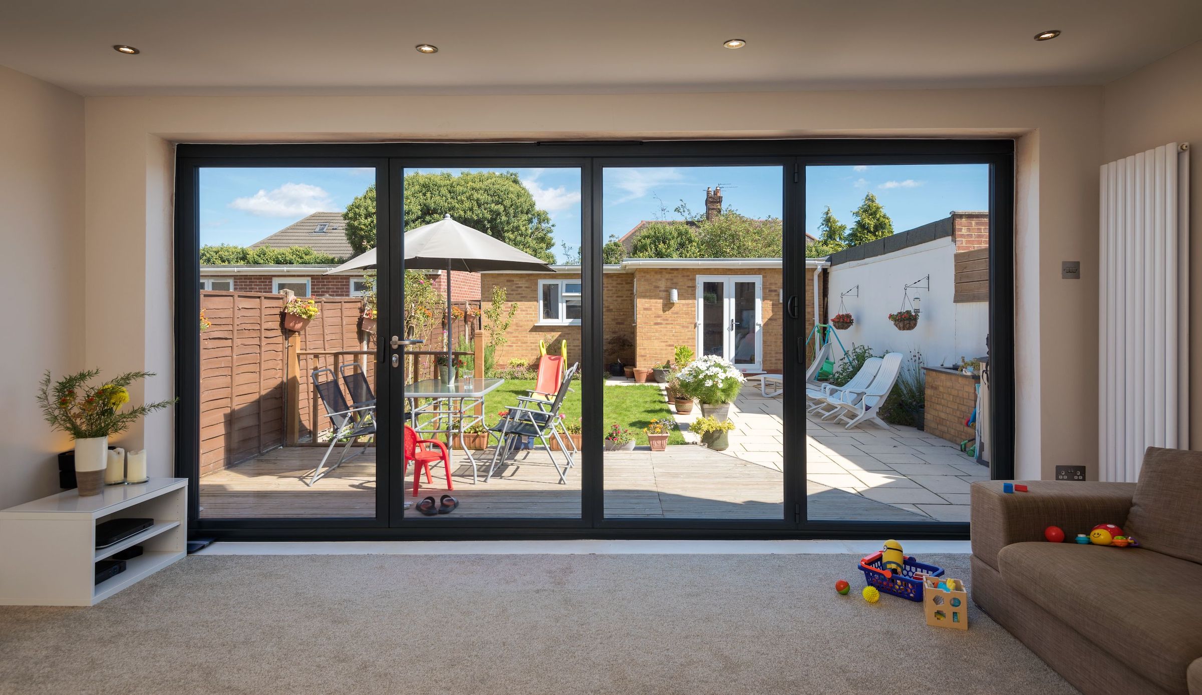 aluminium bifolding doors in a new extension with views of a garden room