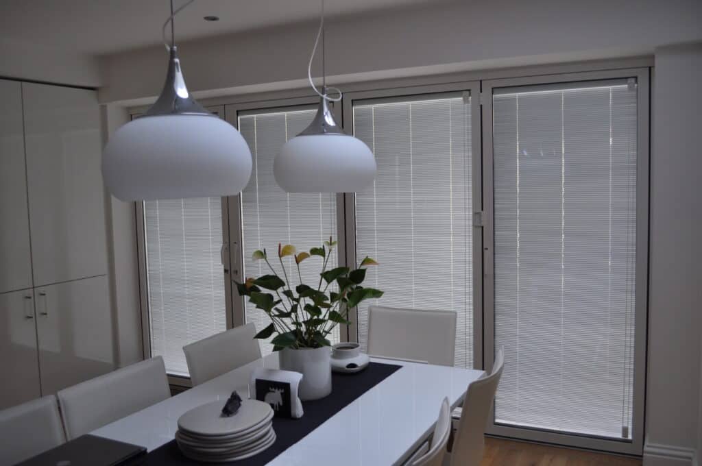 partially open integral blinds in bifold doors white colour