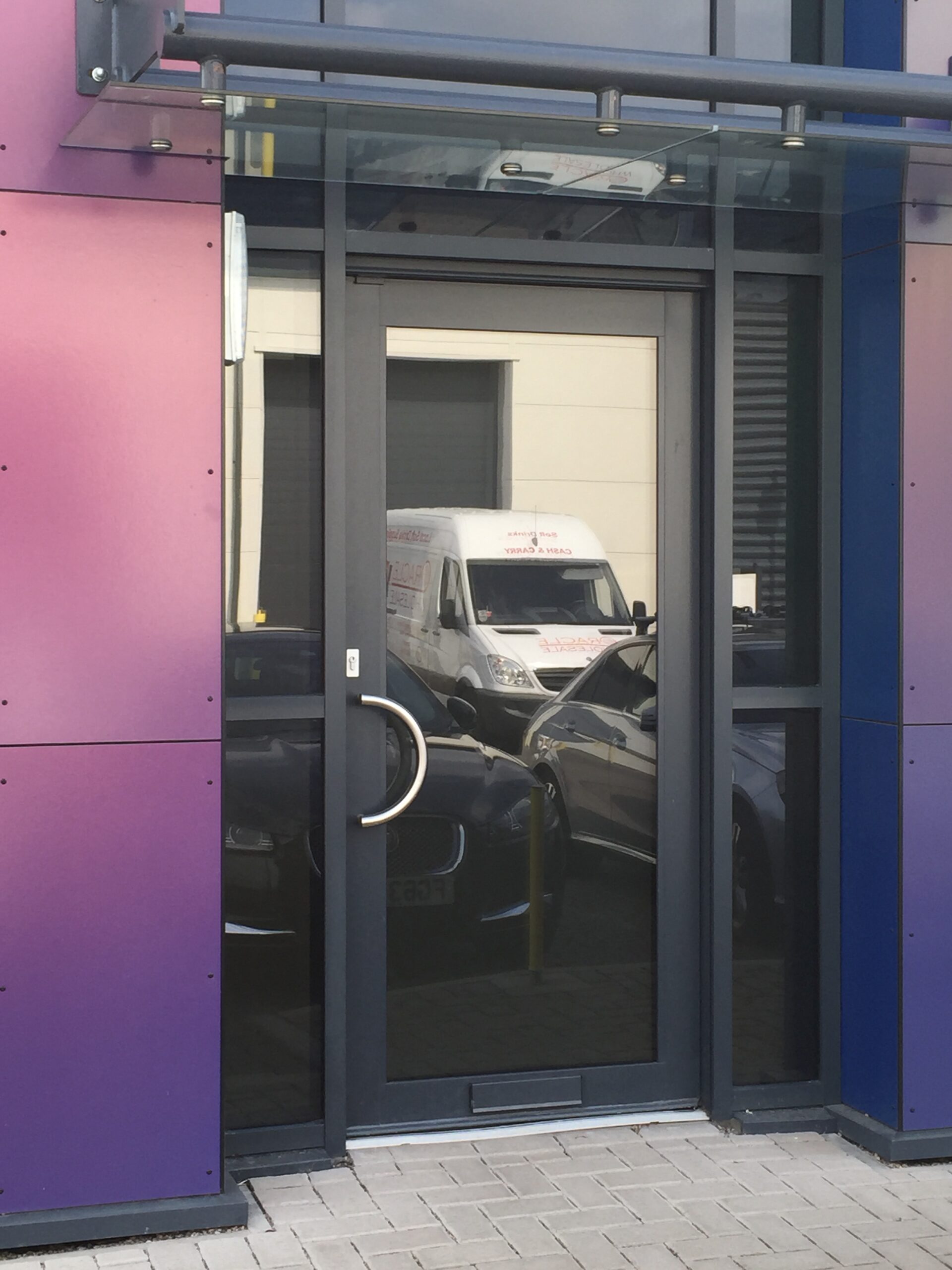 grey commercial door to a purple factory building